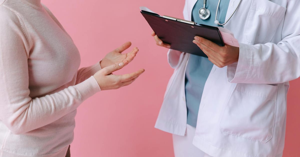Woman reviewing a health screening reminder on her phone, representing cervical screening frequency guidance